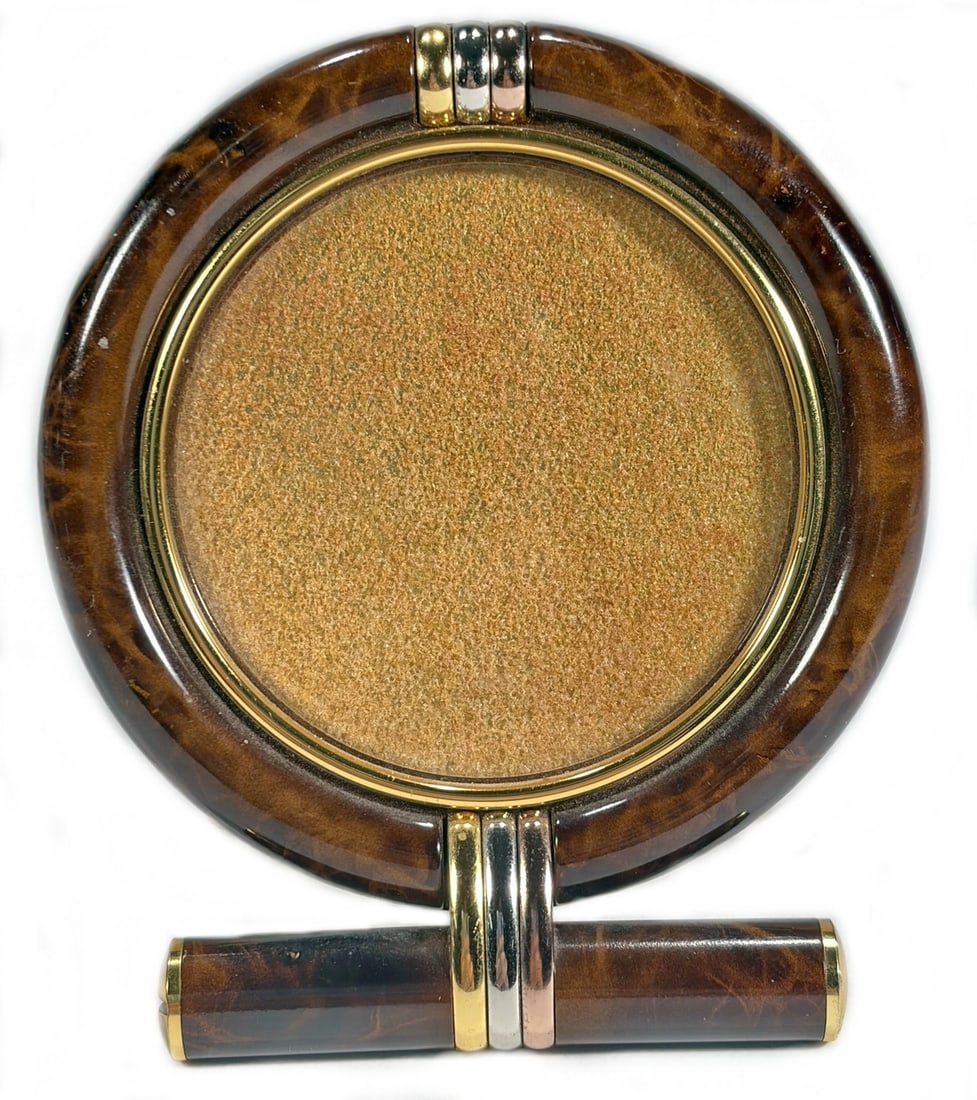 Les Must de Cartier Gilt Round Picture Frame 3.25": Cartier, Les Must de Cartier round gilt picture frame with tortoiseshell style surround and tricolor accents. Reverse stamped 'les must de Cartier Paris,' numbered '8522 02101' and marked 'SWISS MADE.