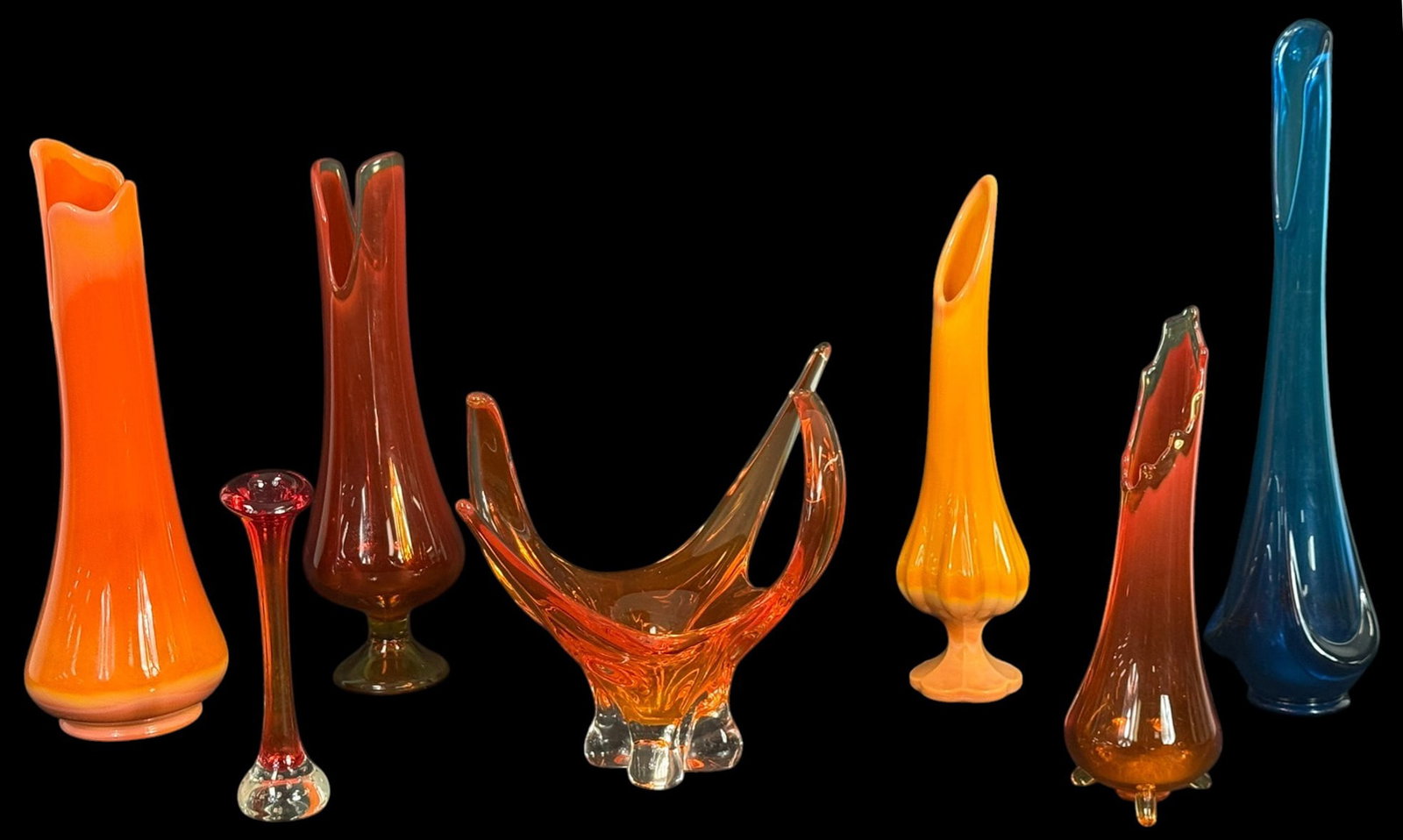 Fayette Glass by LE Smith & & Center Bowl 7pc LOT: Lot of seven mid-century hand-blown art glass pieces. The lot includes pedestal, swung, and tri-footed forms, with one sculptural centerpiece bowl. Several pieces display the signature vivid coloratio