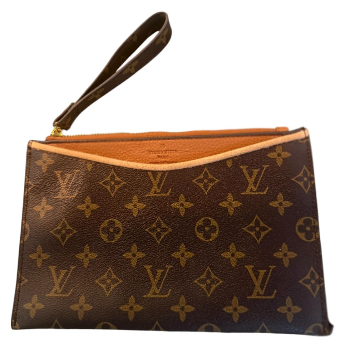 Designer Inspired LV Monogram Wristlet Clutch: Compact wristlet clutch features a designer-inspired monogram canvas leather. The piece includes a tan colored trim and gold-tone zipper, with a convenient wrist strap for easy carrying.Dimensions: 6.