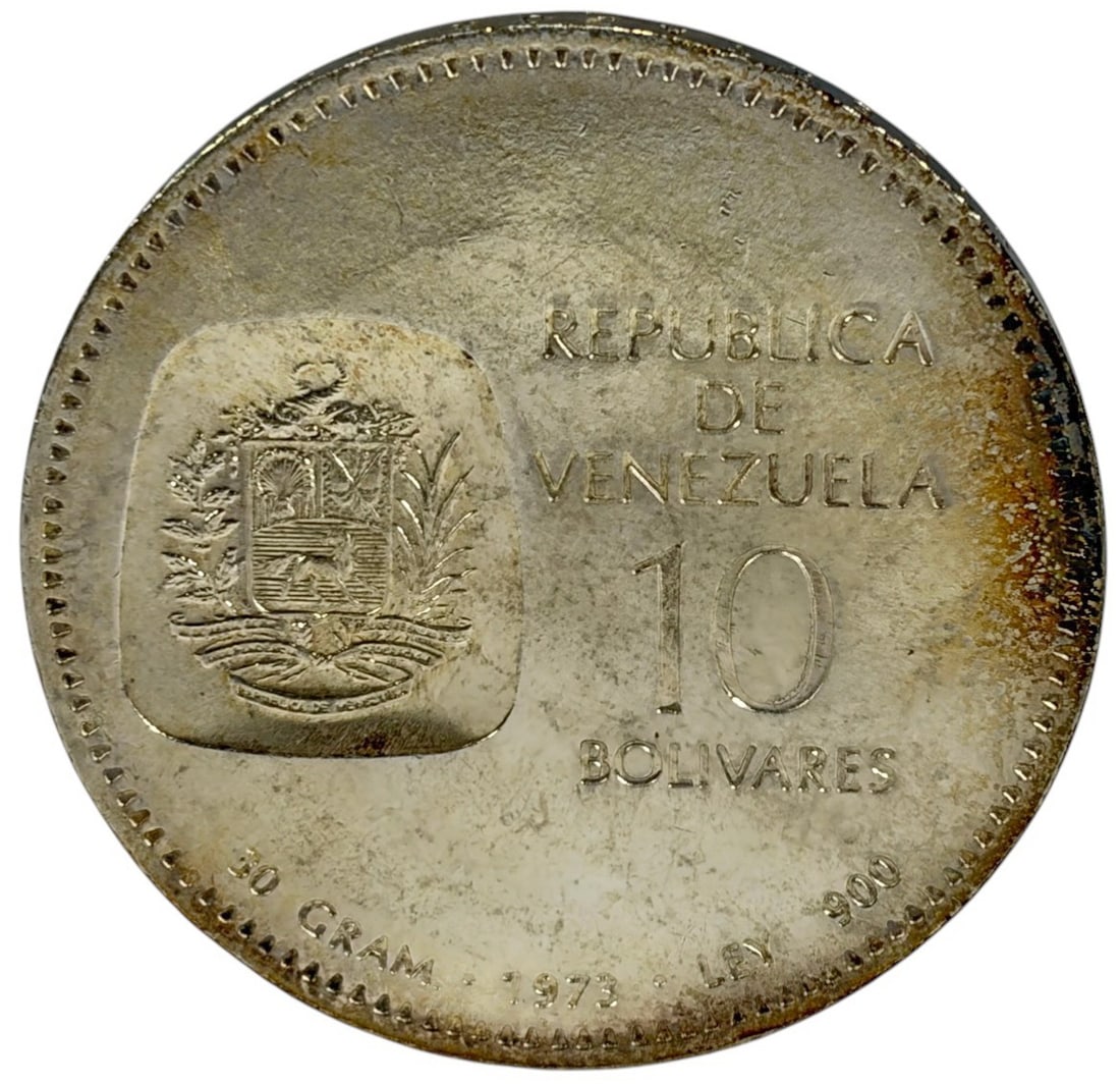1973 Venezuela 10 Bolivares 30 g .900 Silver Coin: Republica de Venezuela, 1973 silver 10 Bolivares commemorative coin honoring Simon Bolivar, with portrait and dates 1873 - 1973 on the obverse and the national coat of arms on the reverse. The coin me