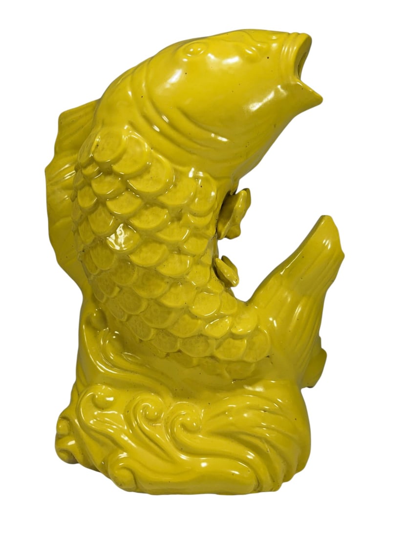 Large Chinese Yellow Glazed Porcelain Koi Fish Fig: Large Chinese porcelain koi fish figure with vibrant yellow glaze, modeled rising from stylized waves with detailed scales and open mouth. Possibly in the style of a Gluggle Jug.Dimensions: 15 X 10.75