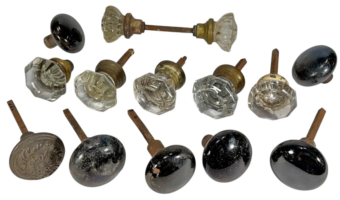 Antique Glass, Bronze & Iron Door Knobs 14pc LOT: Assorted collection of antique architectural door hardware including glass, bronze, and iron door knobs with spindle shafts and mounting components. Includes clear faceted glass examples and a cast br