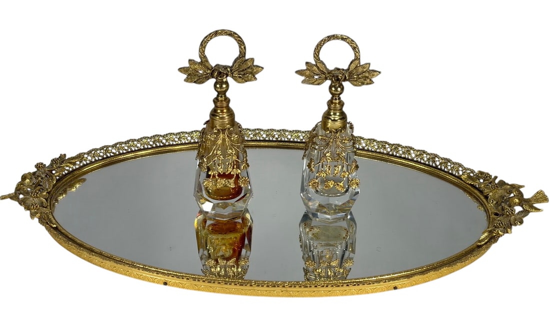 VTG Gilt Metal & Glass Perfume Bottles & Tray 3pcs: Vintage three-piece vanity set including a gilt metal mirrored tray and two cut glass perfume bottles with gilt overlay mounts and dipper stoppers. The largest measures approximately 1 inch tall by 18