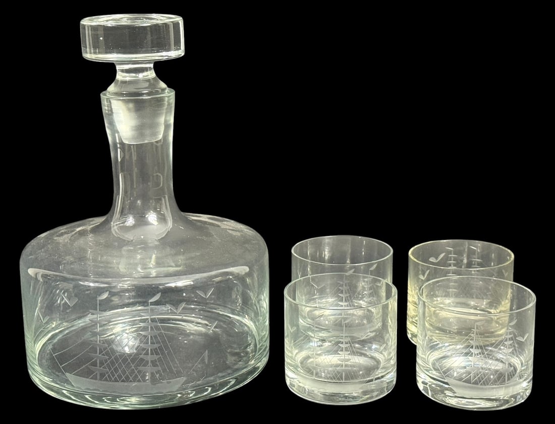 Modern Etched Sailing Ship Decanter & Tumbler 5pcs: Modernist clear glass decanter and four matching tumbler glasses featuring etched sailing ship designs. The decanter includes a fitted stopper and rounded body with nautical motif matching the tumbler