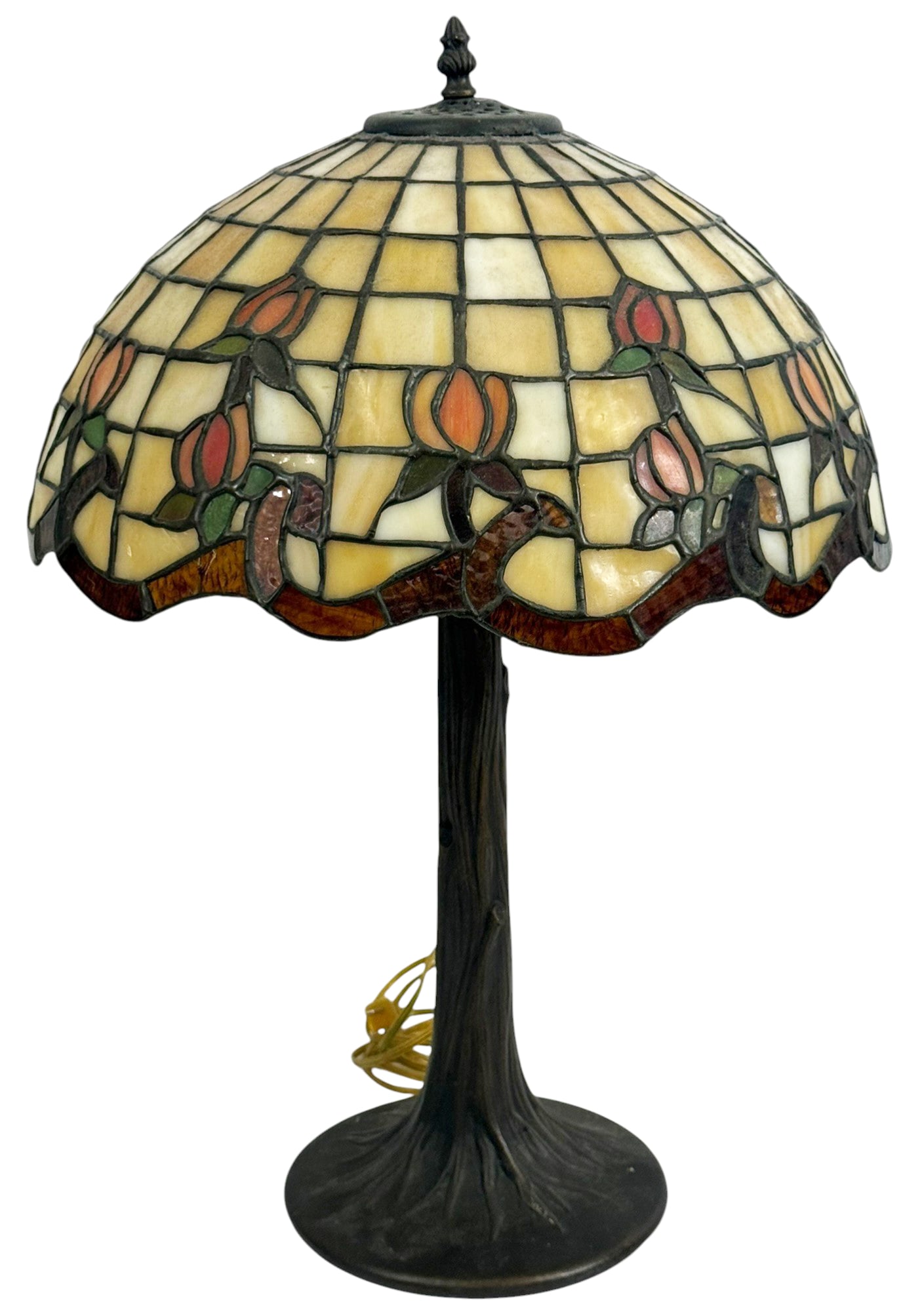 Tiffany Style Tulip Stained Glass Table Lamp: Tiffany style table lamp featuring a stained glass shade with a repeating tulip motif in orange, red, and green tones set against cream and amber glass panels. The domed leaded glass shade rests on a