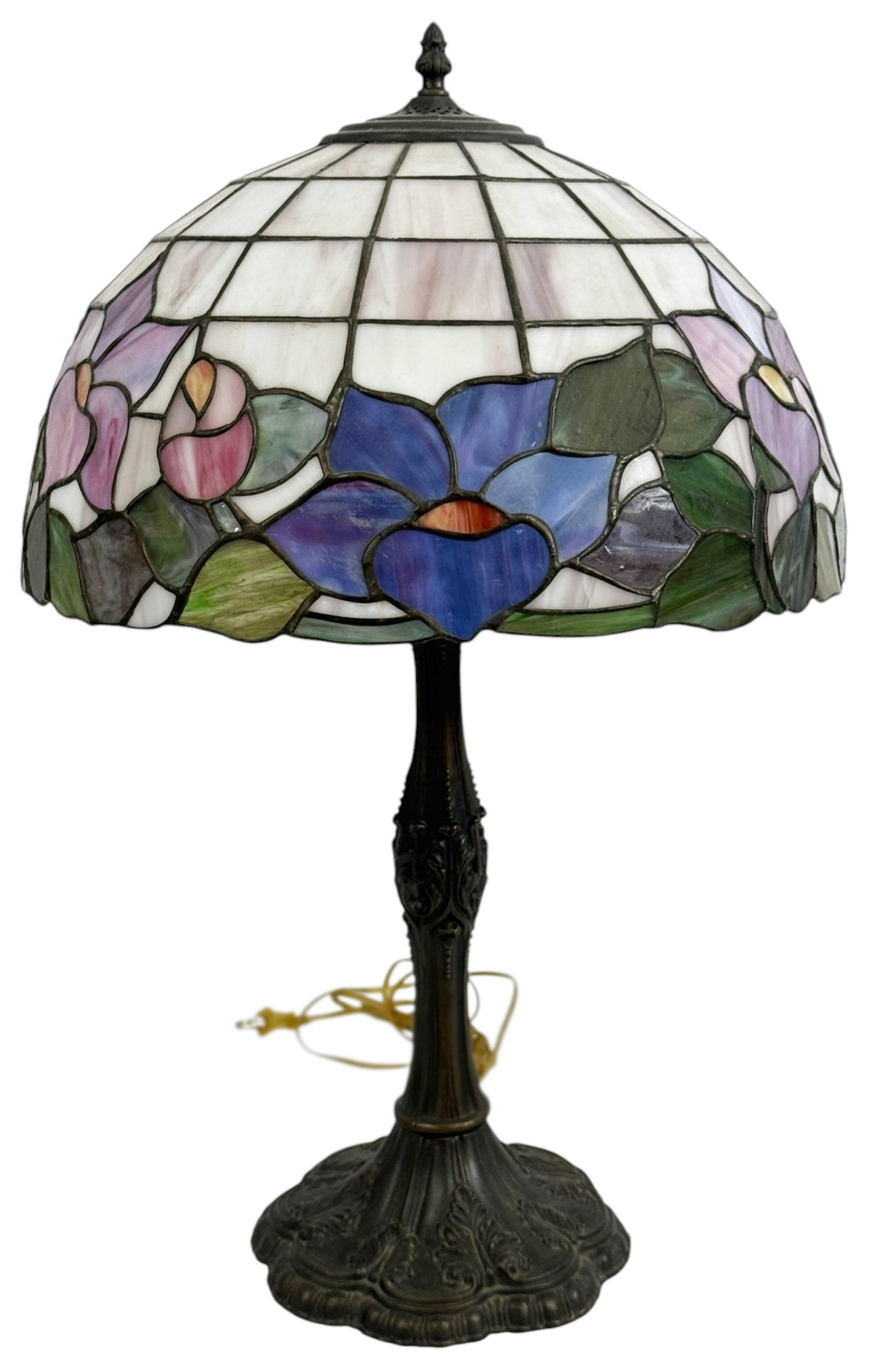 Tiffany Style Floral Stained Glass Table Lamp 26": Tiffany style table lamp featuring a stained glass shade with blue and pink floral motifs and green leaves. The domed shade is composed of leaded glass panels above an ornate bronze tone metal base.Di