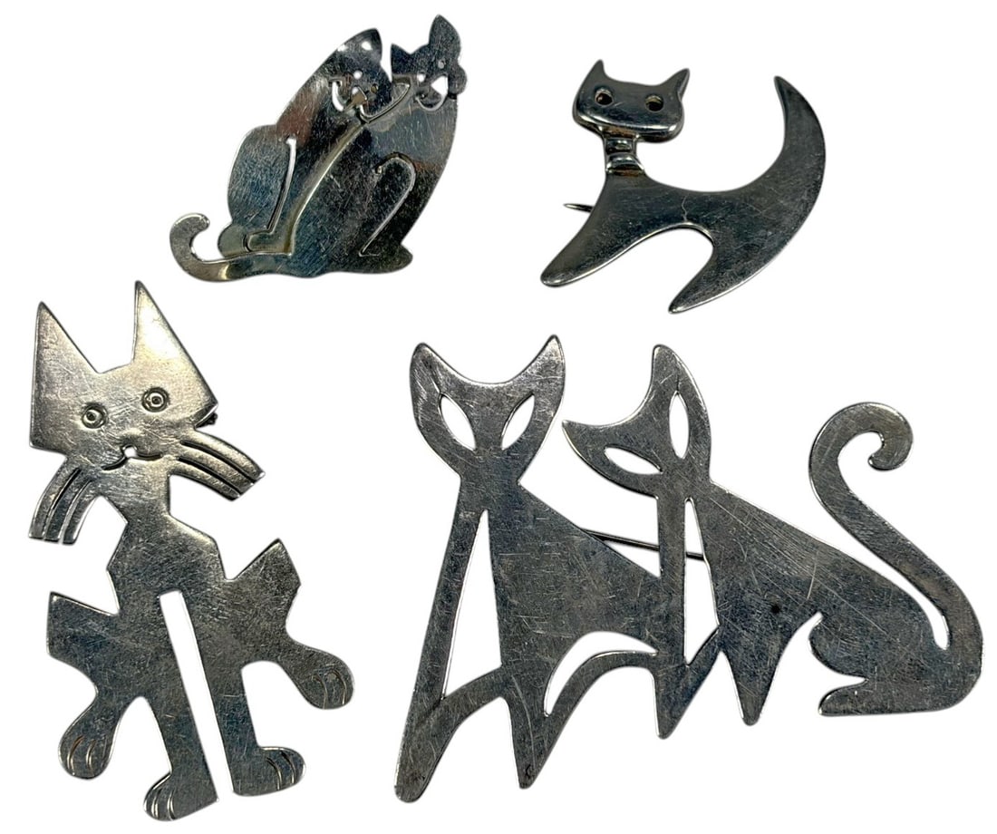 Sterling Silver 925 Cats Brooches 4pc LOT: A group of four sterling silver cat form brooches in modernist design. One is marked 925 and Taxco Mexico. The largest piece is 2 x 2.5 x 0.25 inches. Total weight is 47 grams. Condition: Good overall