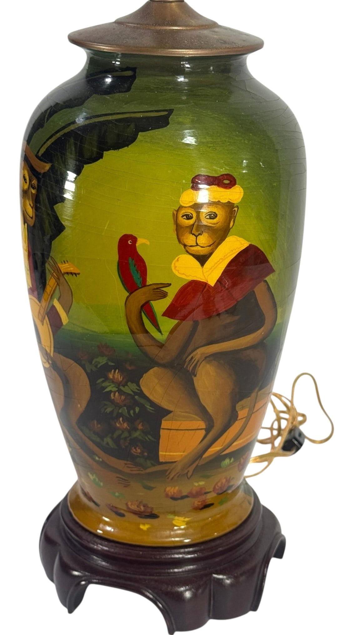 Courting Monkey Musician Figural Scenic Table Lamp: Vintage hand-painted glazed figural table lamp with monkeys in period dress seated in a landscape, one playing a string instrument and another holding a bird. Mounted on a carved wood base with metal