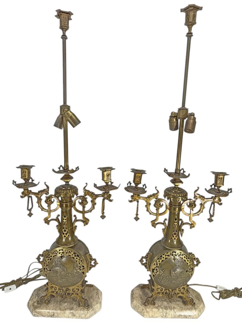 Antique French Pair Gilt Bronze Candelabra Lamps: Pair of antique French gilt bronze lamps with ornate figural and scrollwork decoration, multi-arm candle-style fittings, and marble bases, featuring pierced panels and bird motif, electrified. Each pi