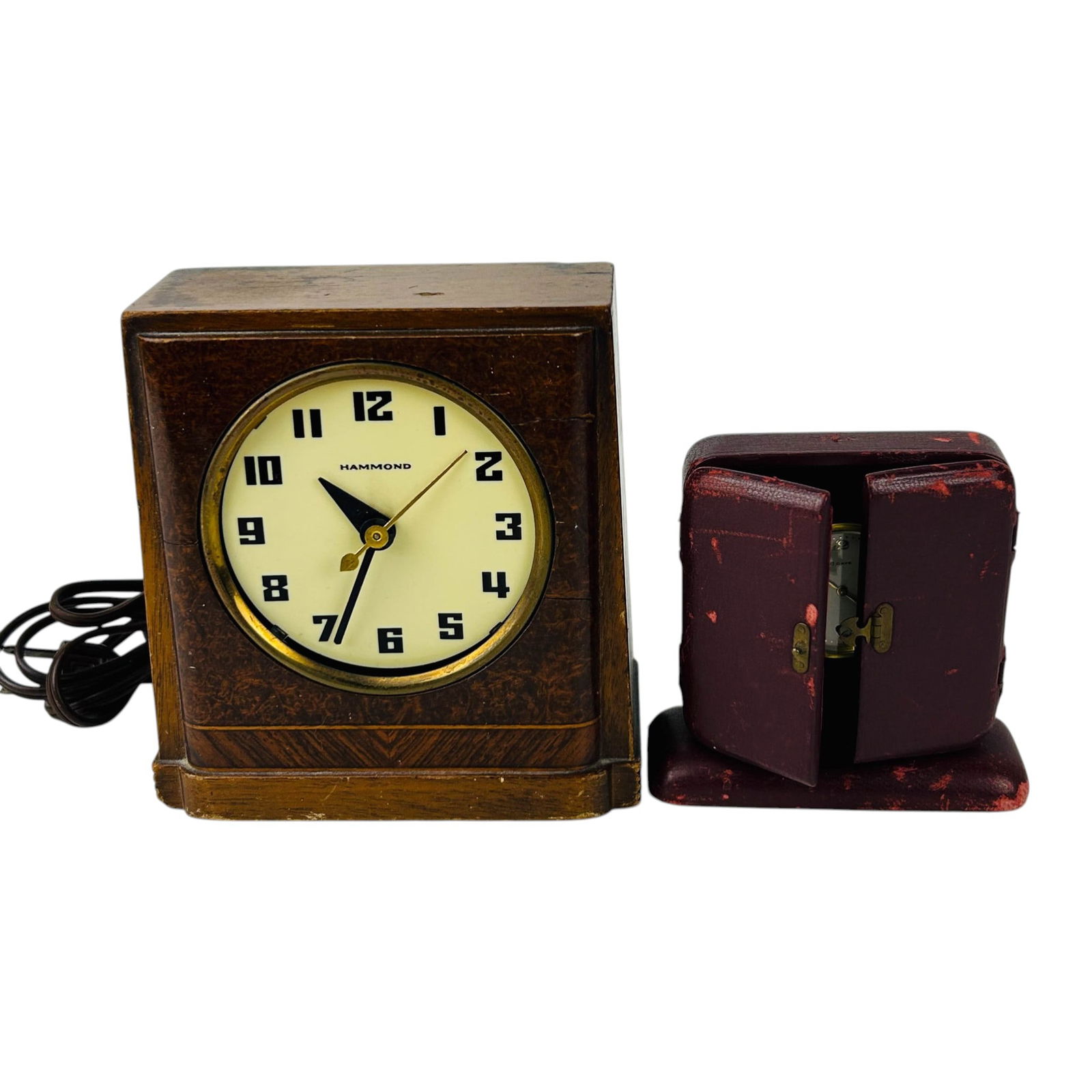 Hammond Luna Clock And Swiss Travel Case Timepiece: Group lot of two timepieces including a Hammond Luna model 316 electric clock and a Swiss eight day travel clock in folding red leather case. Hammond example features wood case, plug cord, rear contro