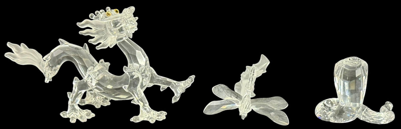 Swarovski Crystal Dragon, Dragonfly, Cobra 3pc LOT: Swarovski, a group of three crystal figurines including a dragon, dragonfly, and cobra snake. The dragon features frosted details with colored crystal eyes, while the dragonfly has frosted wings and a
