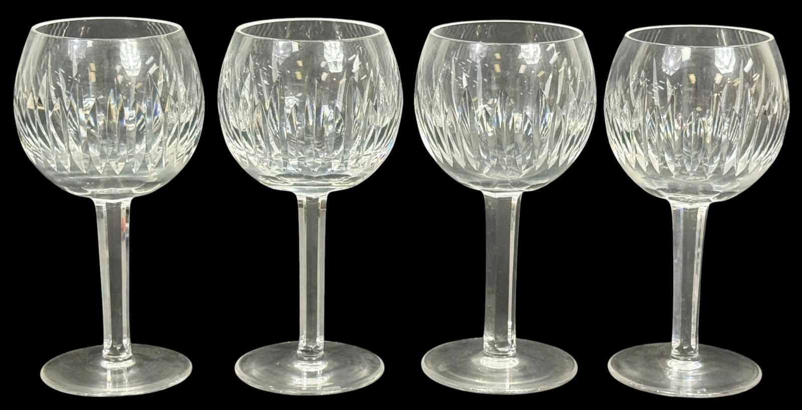Waterford Carina Crystal Balloon Wine Glasses 4pcs: Waterford Crystal Carina pattern balloon wine glasses, offered as a set of four. Each glass features a cut crystal bowl with a faceted stem and clear foot. The glasses are marked Waterford and display