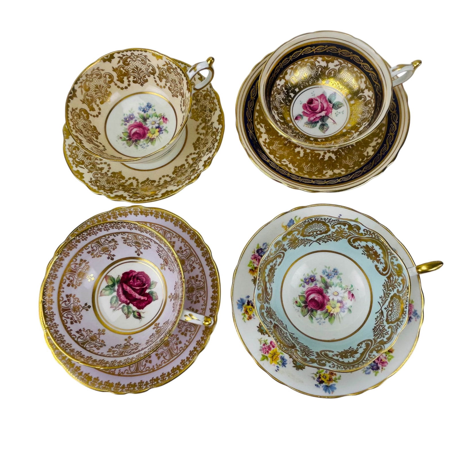 Paragon England Cabbage Rose Teacup Saucers 4 Sets: Group of four Paragon England fine bone china teacups with matching saucers. Each set features a red pink cabbage rose motif within the cup well and saucer center with gilt border decoration. Grounds