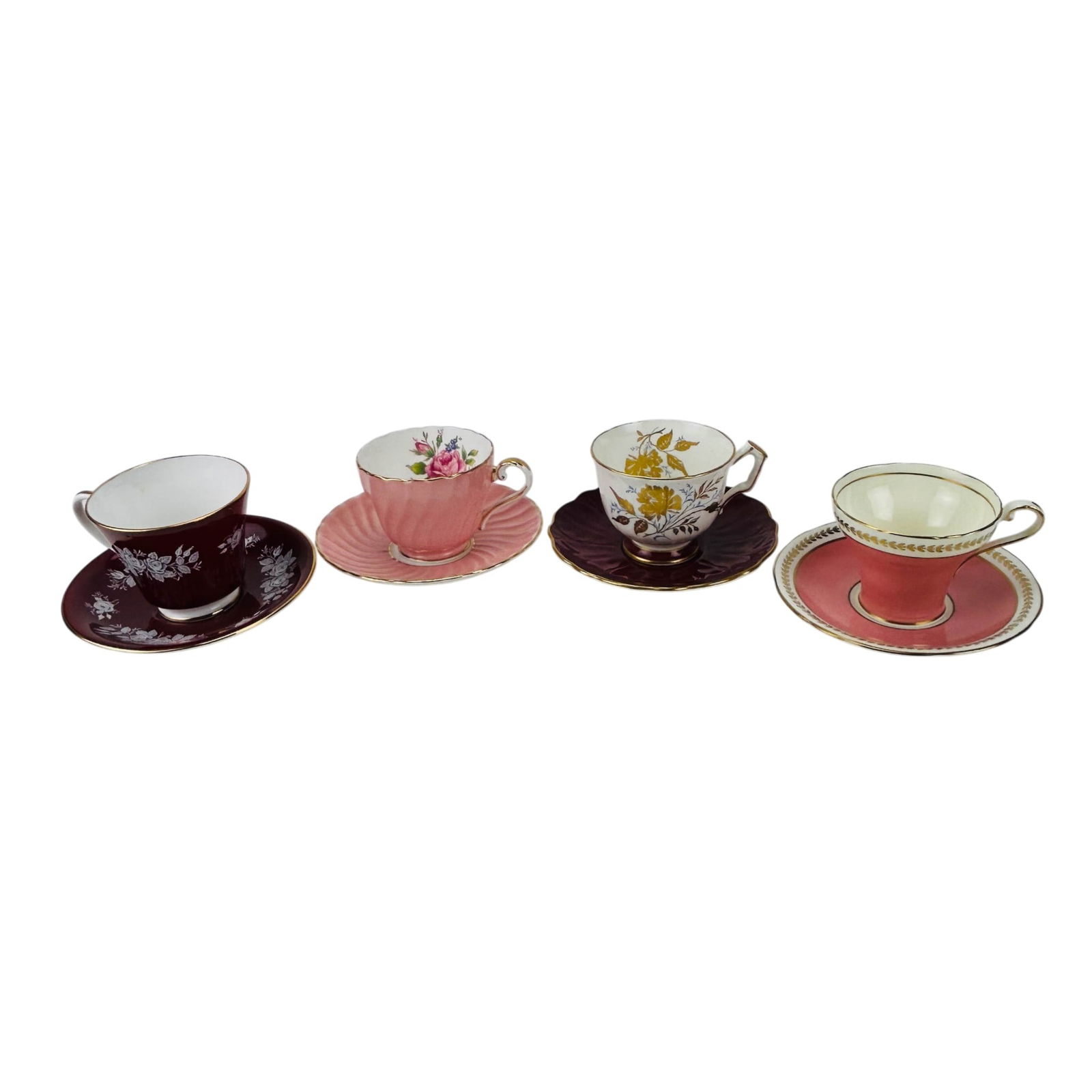 Aynsley Pink Maroon & Gold Gilt Cup Saucer 4pc SET: Group of four Aynsley England bone china teacups with matching saucers. Each example displays pink or maroon red ground decoration with gilt border bands and floral motifs including rose designs and w