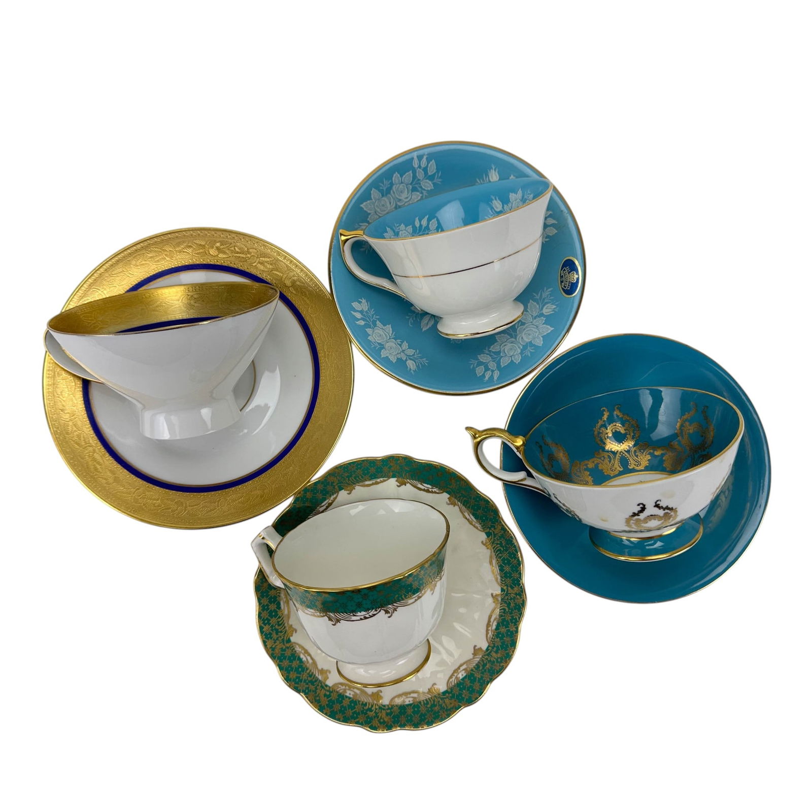 Rosenthal Aynsley Floral Gold Gilt Cup Saucer 4pc: Group of four English and German bone china and porcelain teacup and saucer sets. Includes three examples by Aynsley and one by Rosenthal. Decoration includes turquoise ground with white floral motif,