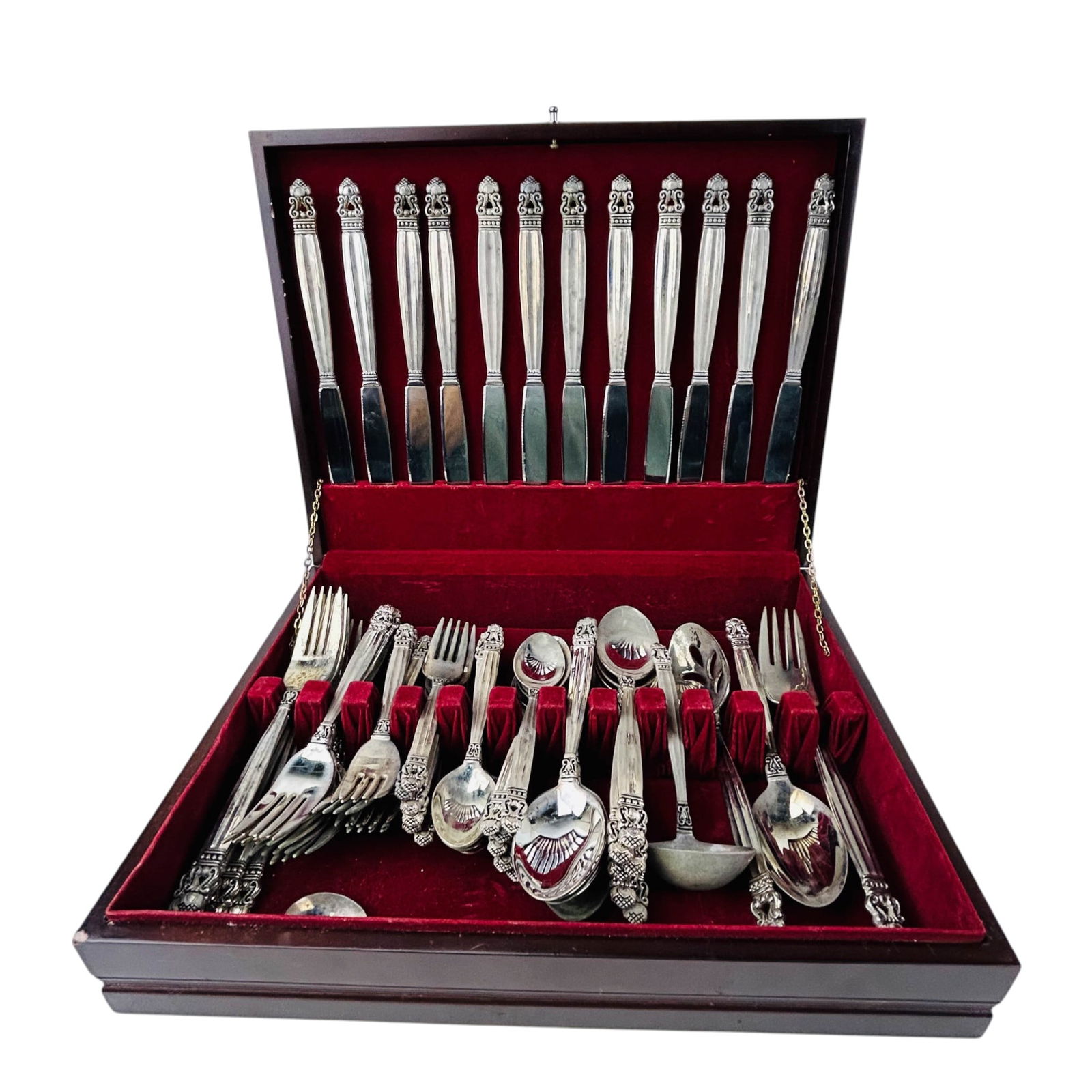 Godinger Silverplate Olde Copenhagen Flatware Set: Godinger Silver plate flatware service in the Olde Copenhagen pattern, presented in a fitted red lined storage chest. The pattern features tapered handles with an ornate acorn and scroll motif termina