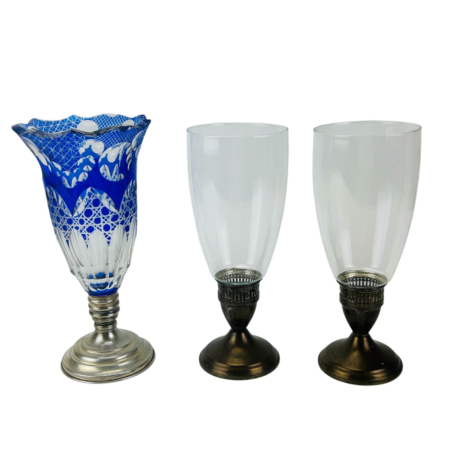 Czech Crystal Vase & Sterling Glass Candleholders: Group of three table items including a Bohemian Czech cobalt blue cut to clear crystal vase with an 800 silver grade base. Accompanied with a pair of clear glass hurricane shades resting in weighted s