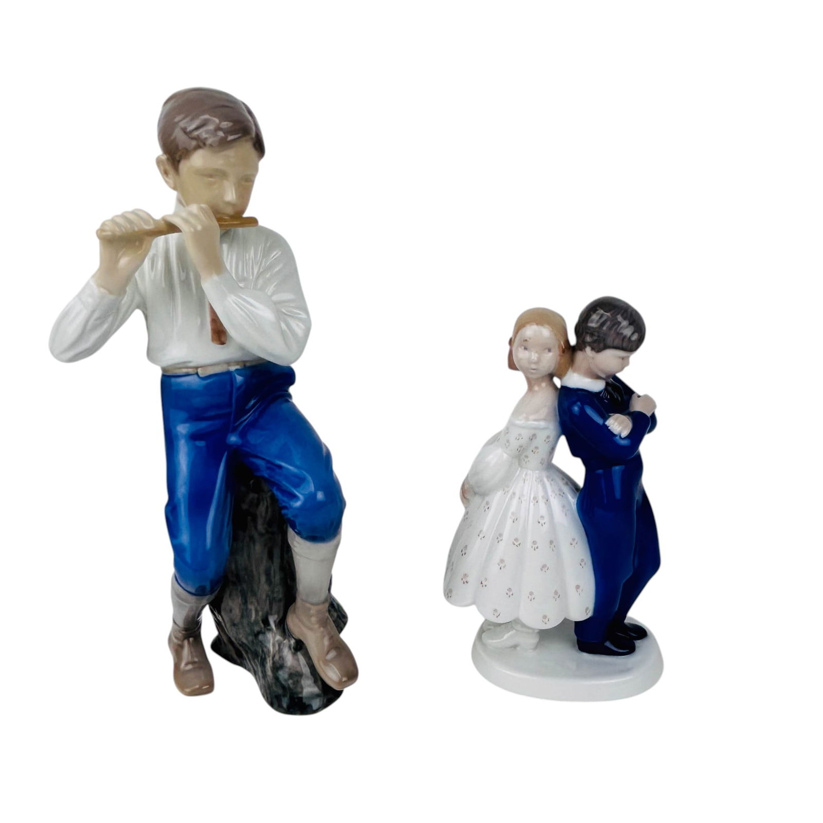 Bing Grondahl Pardon Me & Boy w/ Flute Figurine 2p: Pair of Bing & Grondahl hand painted Danish porcelain figurines. includes Pardon Me #2372 designed by Claire Weiss (Danish, 1906-1997), depicting a young boy and girl standing back to back, and Boy wi