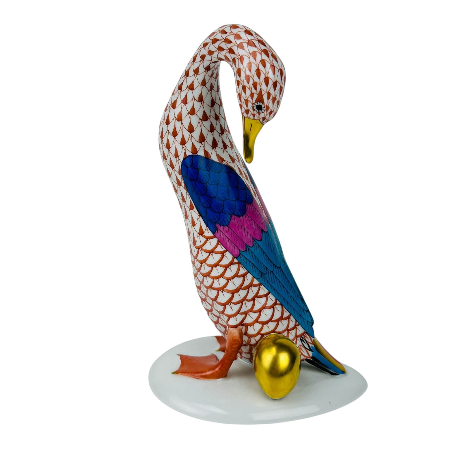 Herend Rust Fishnet Goose w/ Golden Egg Figurine: Herend Hungary Rust Fishnet Goose with Golden Egg hand painted porcelain figurine. Features the company's signature fishnet scale decoration in rust tones across the body, with cobalt blue, turquoise