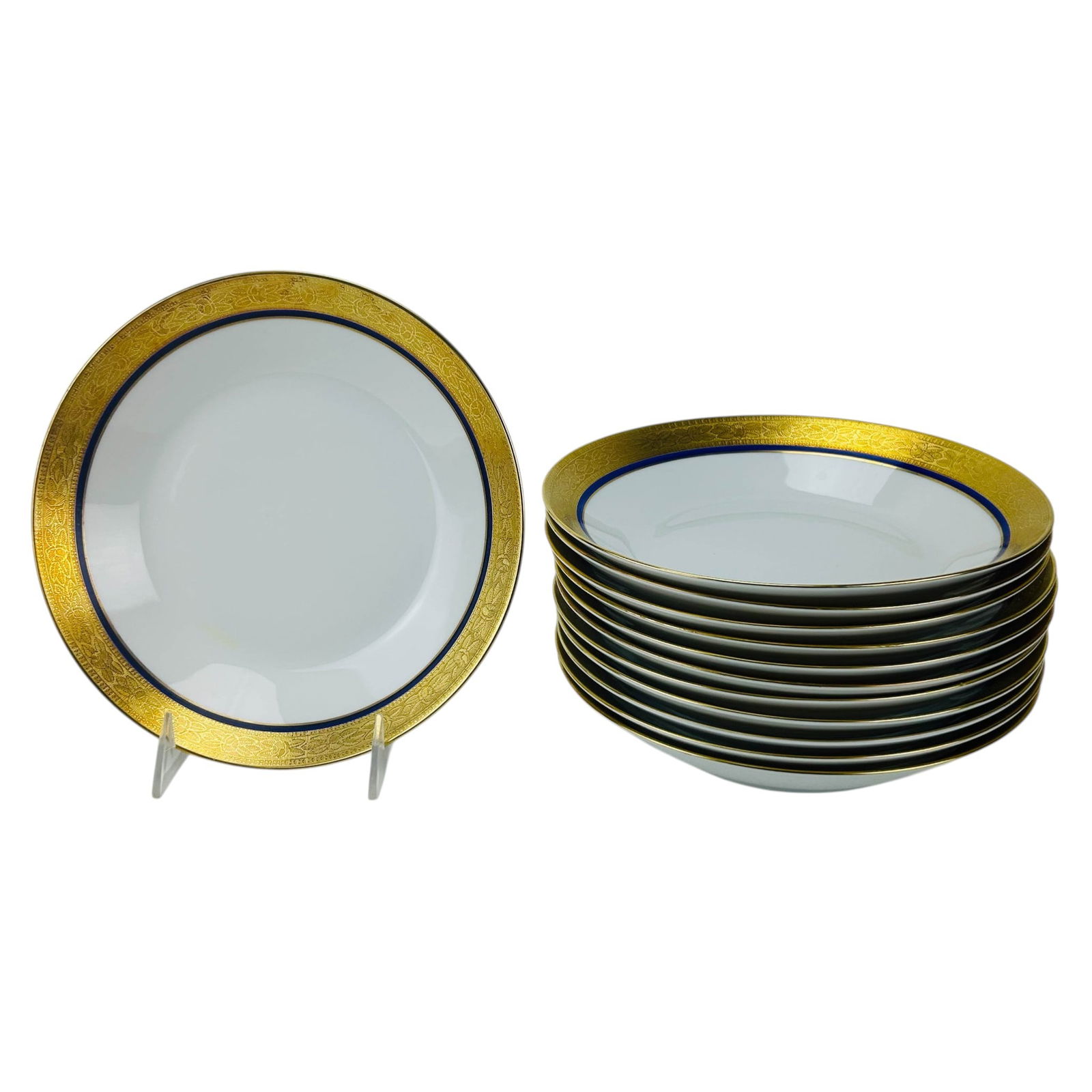 Rosenthal Gold & Cobalt Band Soup Bowls 12pc SET: Rosenthal Germany porcelain rim soup bowls, set of twelve. Each features a wide encrusted gold gilt border with intricate floral engraving and a deep cobalt blue band framing the white center. Undersi