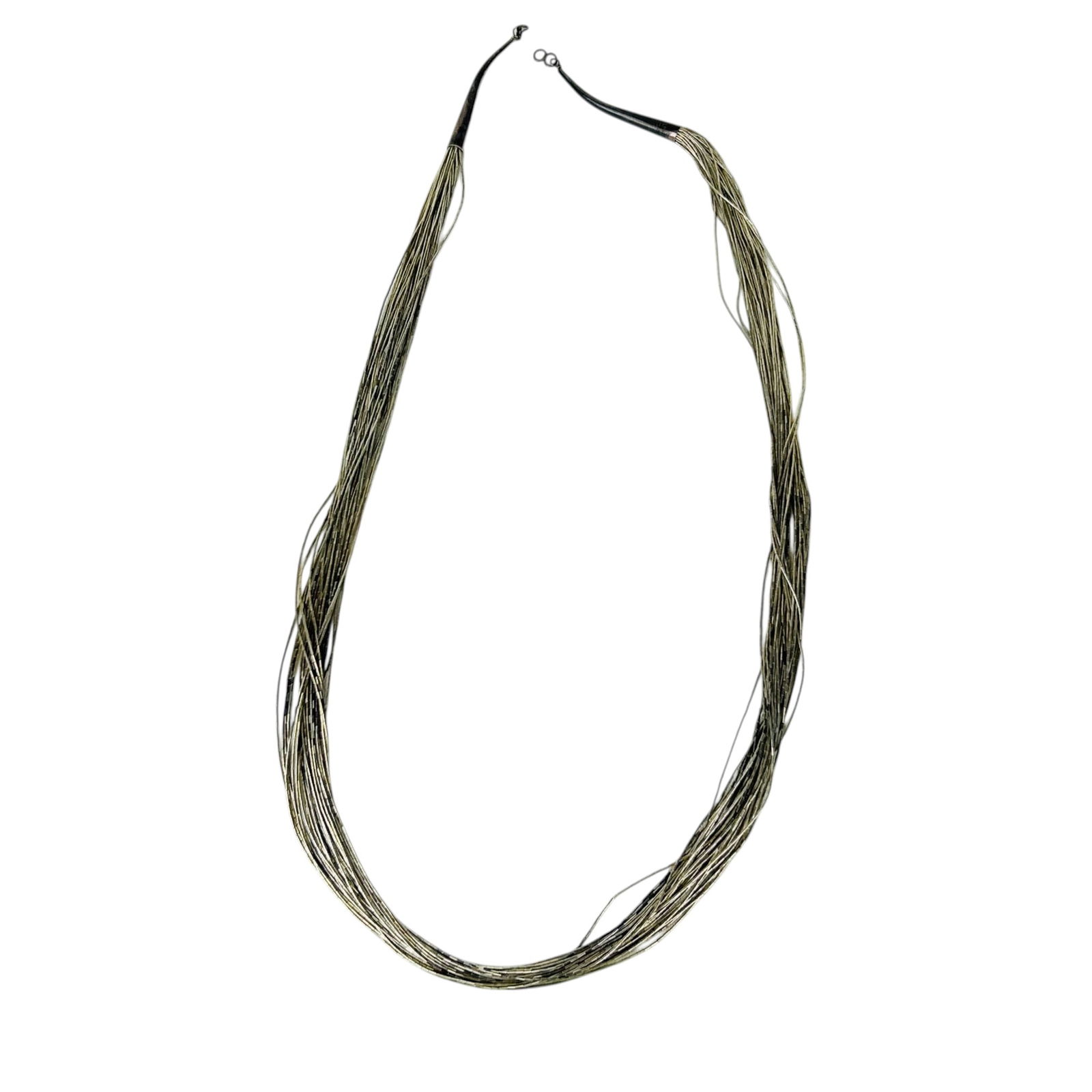 American Indian Style Liquid Silver 925 Necklace: Native American Indian style jewelry necklace composed of a total of thirty sterling silver 925 strands threaded with small tubular beads forming a layered draped design. Ends gathered into tapered st