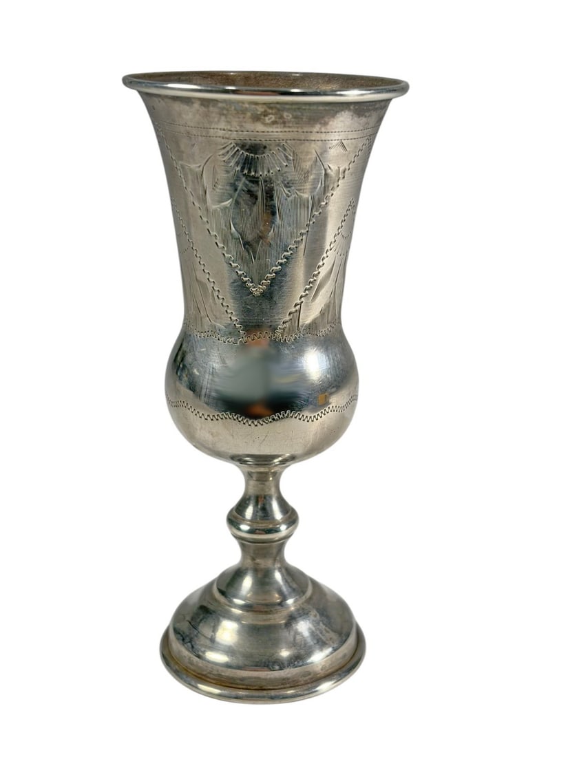 Antique Russian Judaica Sterling Kiddush Goblet: Russian Judaica sterling silver Kiddush goblet with engraved heart and foliate motifs, flared cup and baluster stem on round foot, bearing hallmarks to base, traditional ceremonial form. Total weight