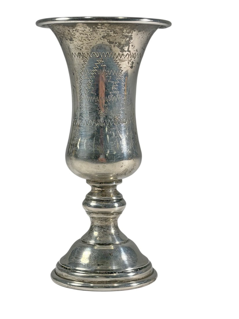 Antique Judaica Sterling Silver Kiddush Goblet: Judaica sterling silver Kiddush wine goblet with baluster form, flared rim, and stepped base, engraved with geometric panel motifs. Marked sterling to the base. Total weight approximately 36 grams.Dim
