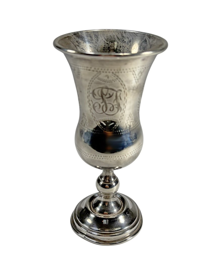 Antique Judaica Sterling Silver Kiddush Goblet: Judaica sterling silver Kiddush wine goblet with baluster form, flared rim, and stepped base, engraved with oval panels, monogram cartouche, and foliate motifs. Marked sterling to the base. Total weig