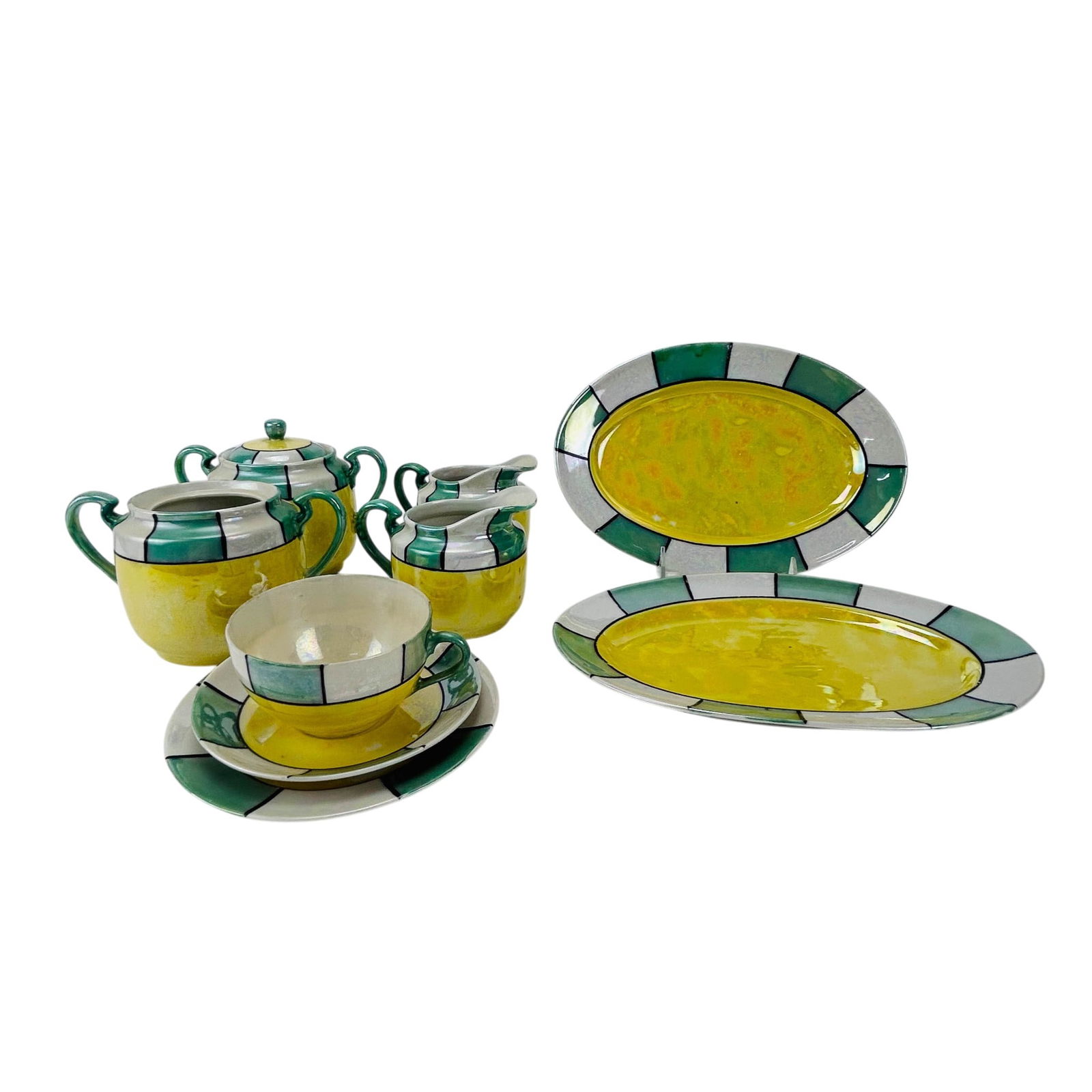 Japanese Porcelain Lusterware Partial Tea Service: Japanese porcelain lusterware partial tea service. Includes two teapots (one with no lid), two milk cream pitcher jugs, two oval trays, one cup with saucer and one bread butter plate. Total of nine pi