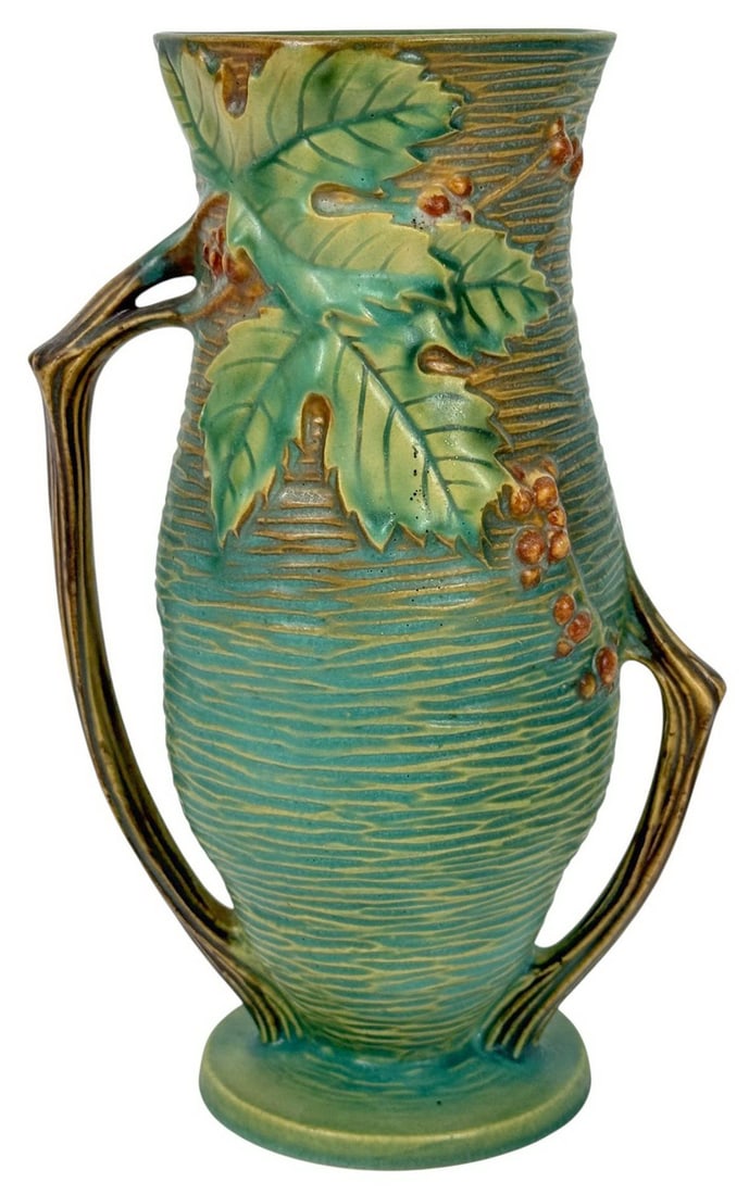 Roseville Pottery Bushberry Double Handle Vase #37: Vintage Roseville American pottery 'Bushberry' vase, model #37-10. Featuring a green and brown blended glaze with embossed berry clusters and leaves with double handles. Circa: mid-20th century. Signe