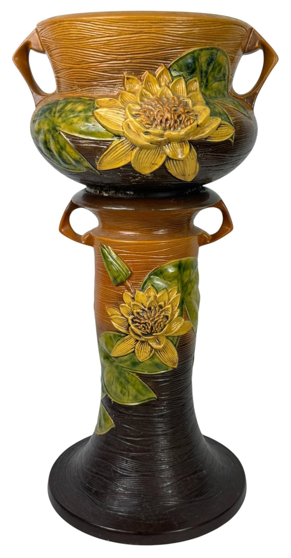 Roseville Water Lily Jardiniere with Pedestal Pair: Roseville vintage American pottery Jardiniere handled planter with its matching pedestal stand, crafted in the 'Water Lily' pattern. Marked 'Roseville USA 663-10' underneath its base. The planter bowl