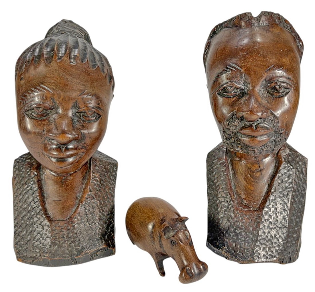 African Carved Wood Busts Man & Woman & Hippo 3pcs: Group of 3 hand-carved wooden figures including two busts and one animal carving, with stylized facial features, textured hair and garments, dark patina, and strong folk art character. The largest mea