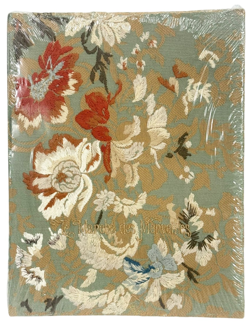 Les Marches des Merveilles Embroidered Fabric Book: Les Marches des Merveilles, a decorative fabric covered volume featuring an ornate floral embroidered design in multicolor thread on a soft green ground. The cover is richly detailed with stylized blo