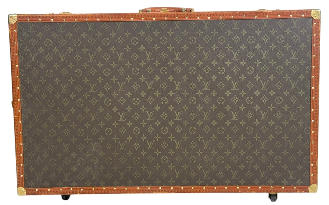 Designer Inspired Monogram Rolling Suitcase: Designer style monogram rolling hard case suitcase trunk featuring the iconic brown monogram canvas design with tan trim, brass tone hardware, and reinforced corner mounts. Dimensions: 21 inches tall