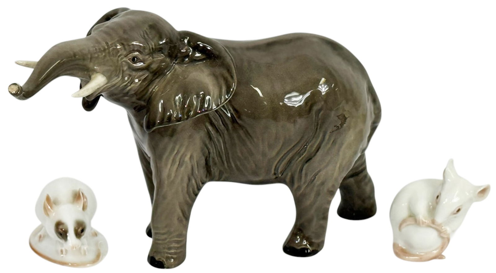 Beswick Elephant, Rosenthal, B&G Mice Figures 3pcs: Beswick English, hand painted porcelain elephant figurine modeled with raised trunk. Accompanied by two small porcelain mouse figurines, each modeled in seated and crouching poses. The mice are made b