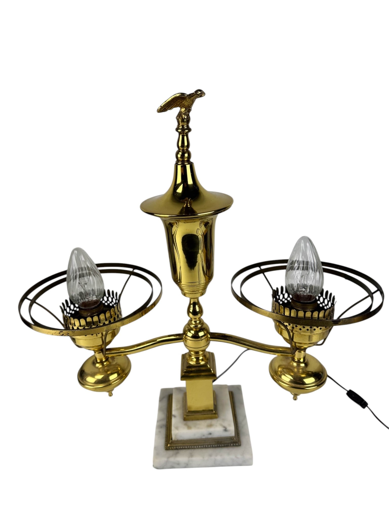 Antique Gilt Brass Glass Shade Double Student Lamp: Late 19th early 20th century brass double student desk table lamp featuring two ribbed emerald green glass shades with white interiors, supported by a central column and scrolling arms. Lamp topped wi