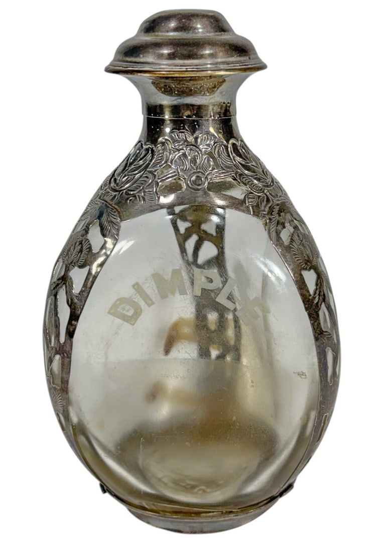 Haig's Dimple Whisky Bottle w Sterling 925 Overlay: Haigs Dimple Scotch whisky glass bottle with sterling silver overlay, pierced and repousse floral decoration, etched DIMPLE branding, silver stamped Sterling 925 with matching cap.Dimensions: 6.75 X 3