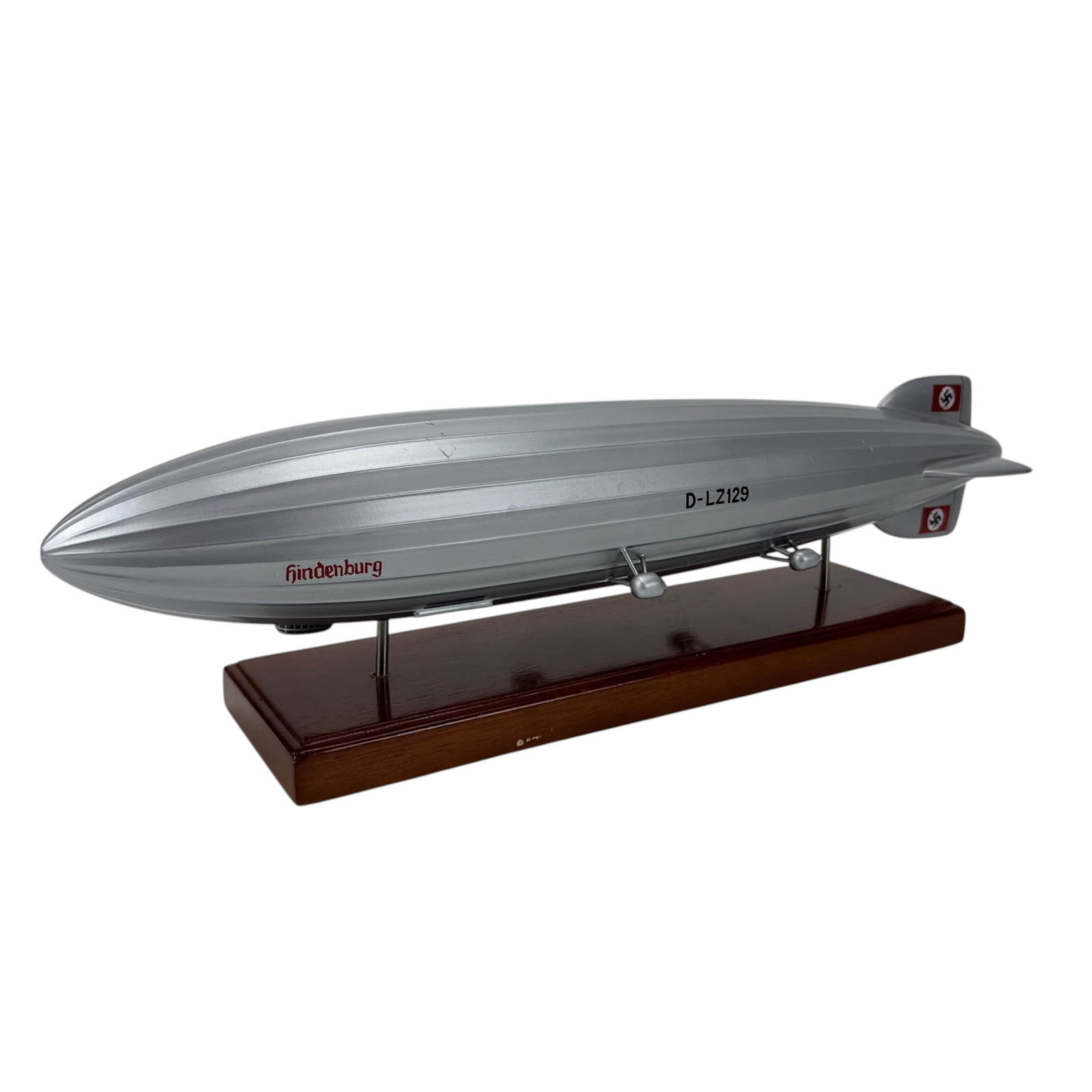 Hindenburg Airship D LZ129 Model Zeppelin Blimp: Scale toy model of the Hindenburg German commercial passenger carrying rigid airship marked D-LZ129. Launched in 1936 by the Zeppelin Company. Mounted on a rectangular wooden display base with metal s