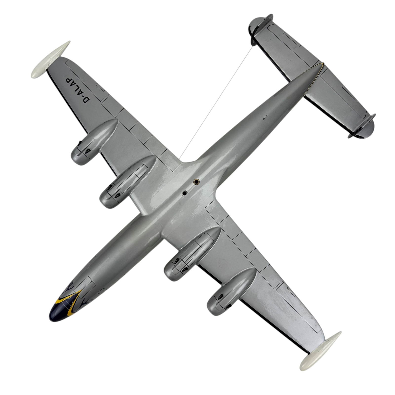 Lufthansa D-ALAP Four Engine Desk Model Airplane: Model airplane marked Lufthansa with registration D-ALAP. Four engine design with printed livery, cockpit windows, and tail markings. Includes wing supports with string rigging and mounted tail assemb
