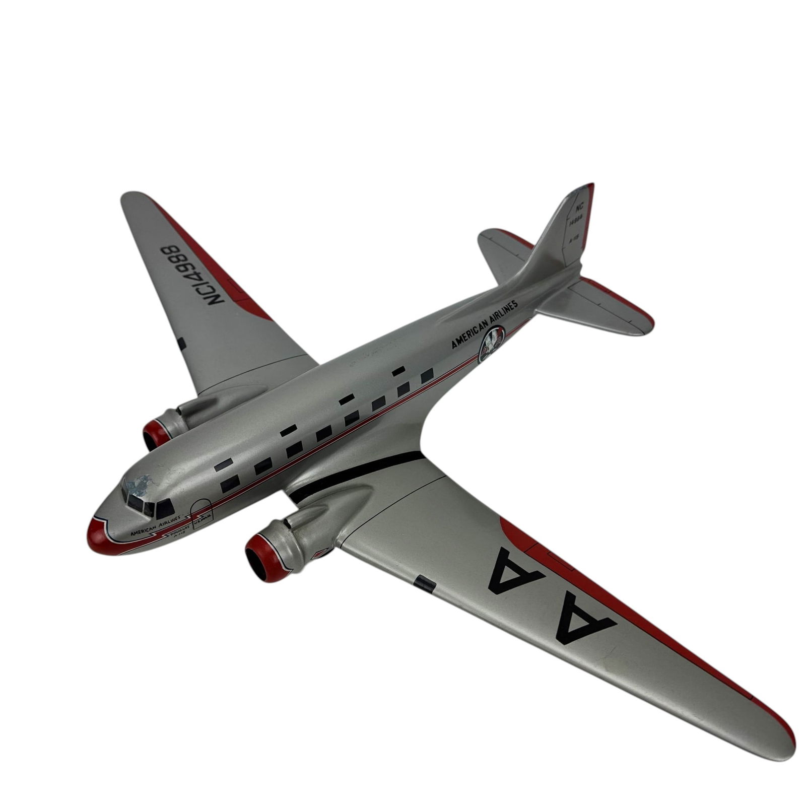 American Airlines Twin Engine Airplane NC14988 AA: Desk top model aviation aircraft in American Airlines livery with silver body, red accents marked NC14988. Twin engine form with window details, AA logos, and U.S. Mail Flagship Texas markings. Constr
