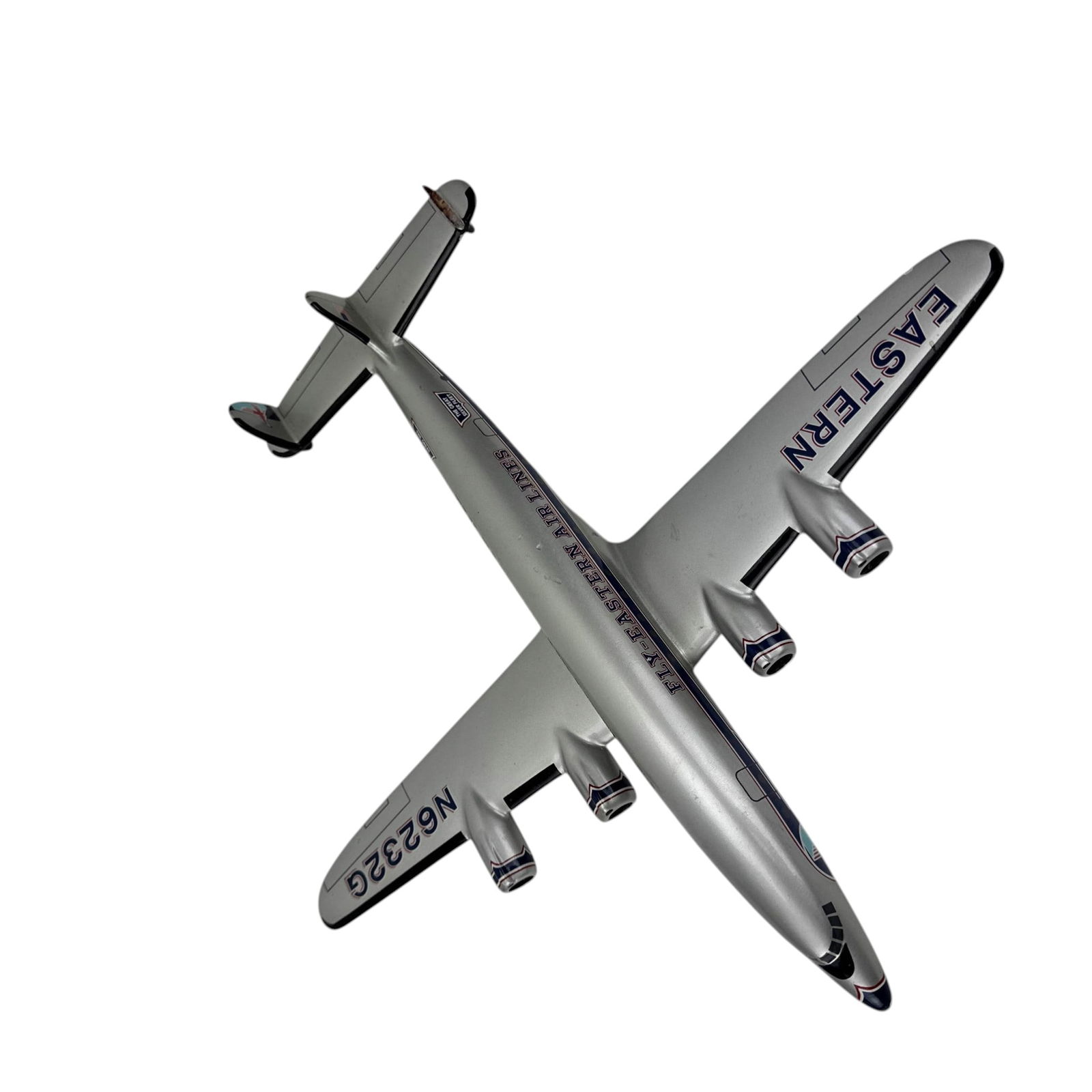 Eastern Airlines 4 Engine Model Airplane N6232G: Desk top aviation aircraft model in Eastern Air Lines livery with silver body, blue and red striping, and marked N6232G. Four engine design with Fly Eastern Air Lines and Great Silver Fleet markings.D