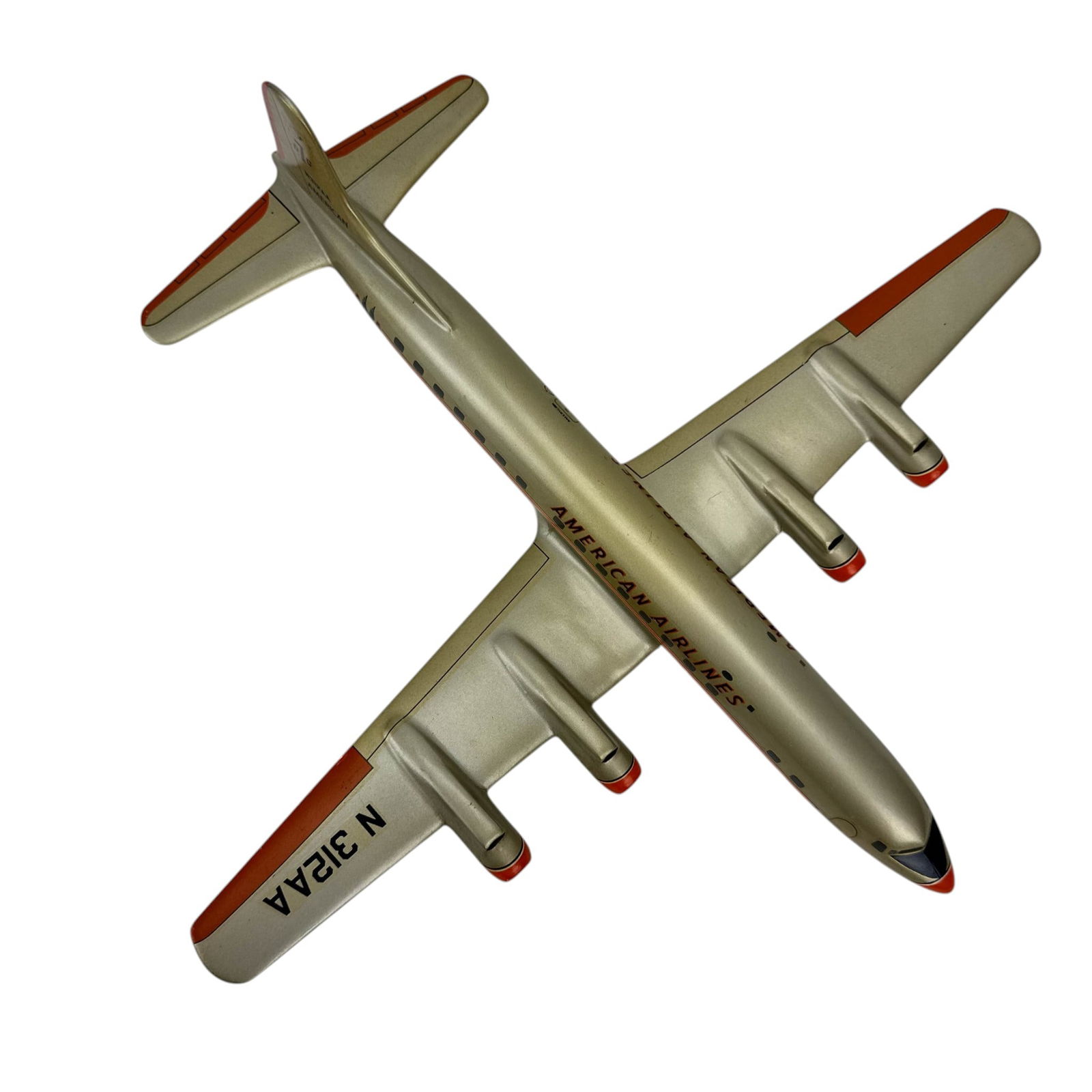American Airlines DC-7 Desk Model Airplane N312AA: Model aviation aircraft in American Airlines livery marked DC-7 and N312AA, featuring a silver tone body with orange accents and four engines. Displays airline branding, fuselage windows, and tail mar
