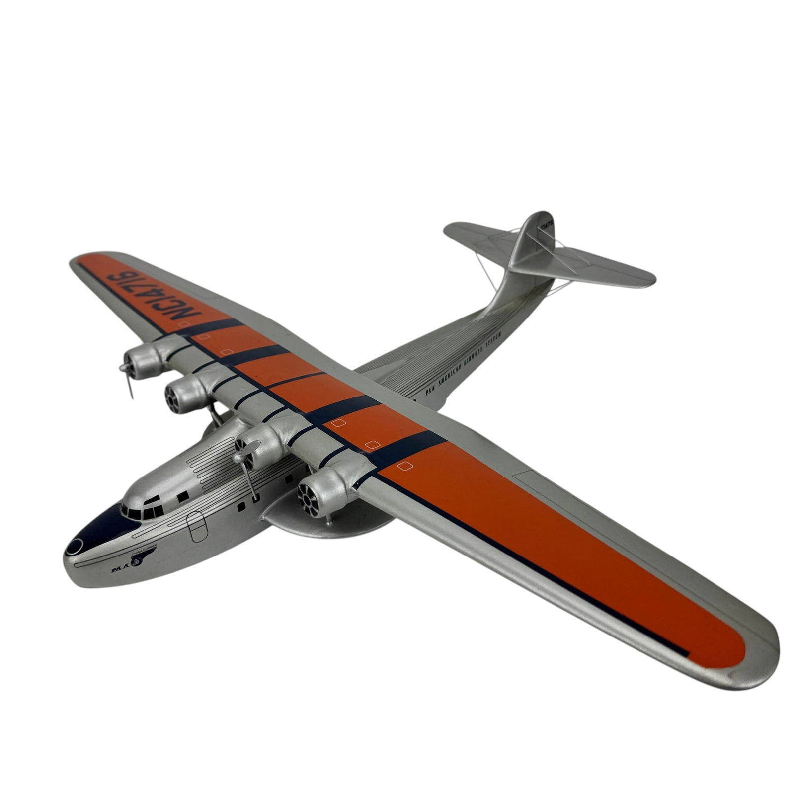 Pan Am China Clipper Flying Boat Model NC14716: Aviation desk model seaplane in Pan American Airways System livery marked NC14716. Depicts a multi engine flying boat with high mounted wing, float supports, and propellers. Displays China Clipper mar
