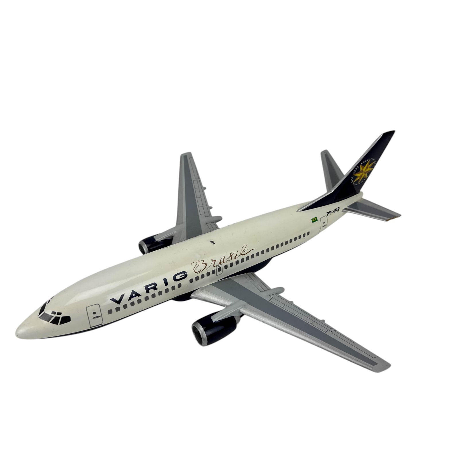 Varig Brasil PP-VNF Model Twin Engine Airplane: Aviation desk model airplane in Varig Brasil livery marked PP-VNF with Brazilian flag detail and star logo on tail. Features twin engine jet configuration with under wing engines, molded fuselage wind
