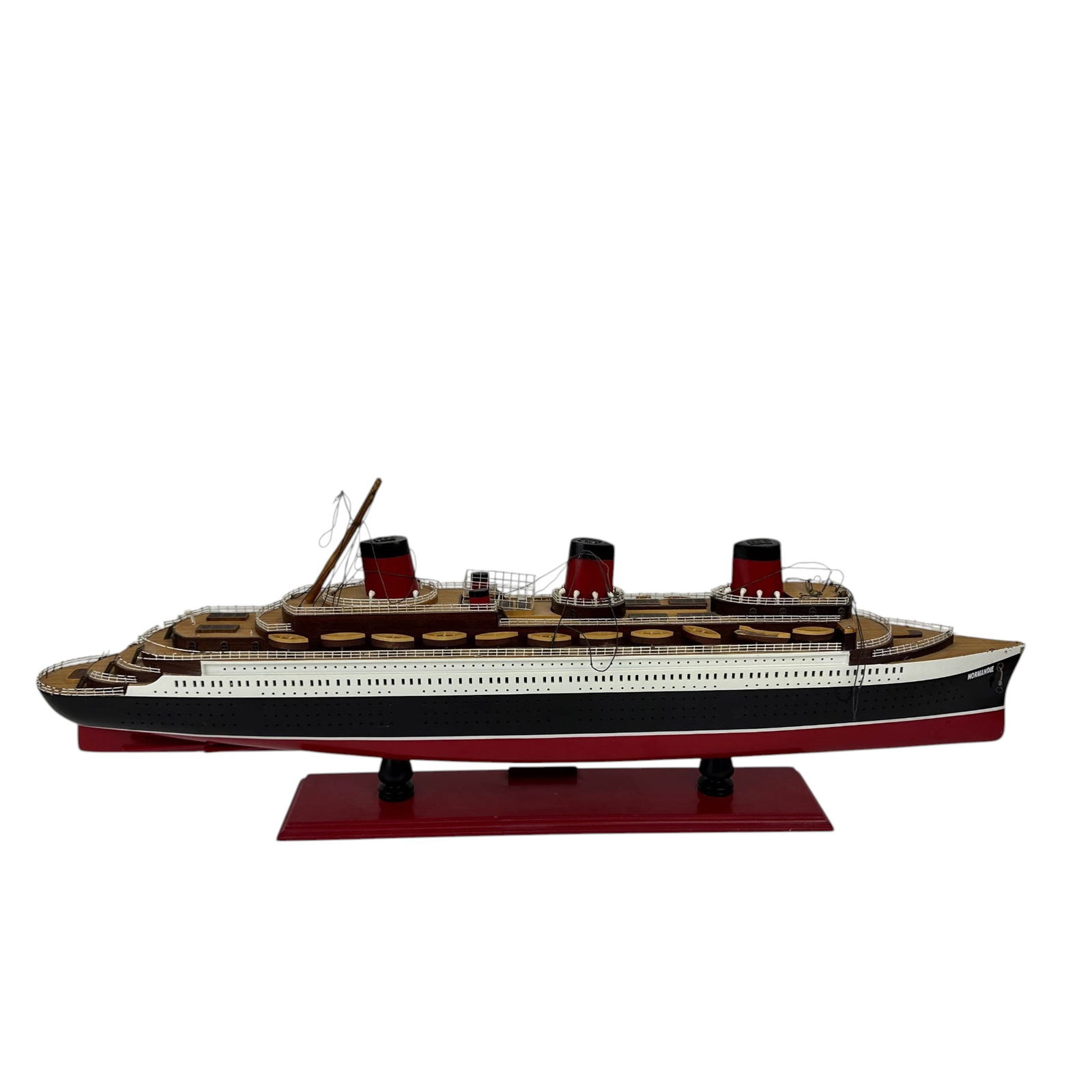 SS Normandie Ocean Liner Boat Ship Display Model: Scale model of the famed French ocean liner SS Normandie, mounted on a red display base with name plaque. Features a painted hull in black, white, and red, with detailed deck structures, lifeboats, ra