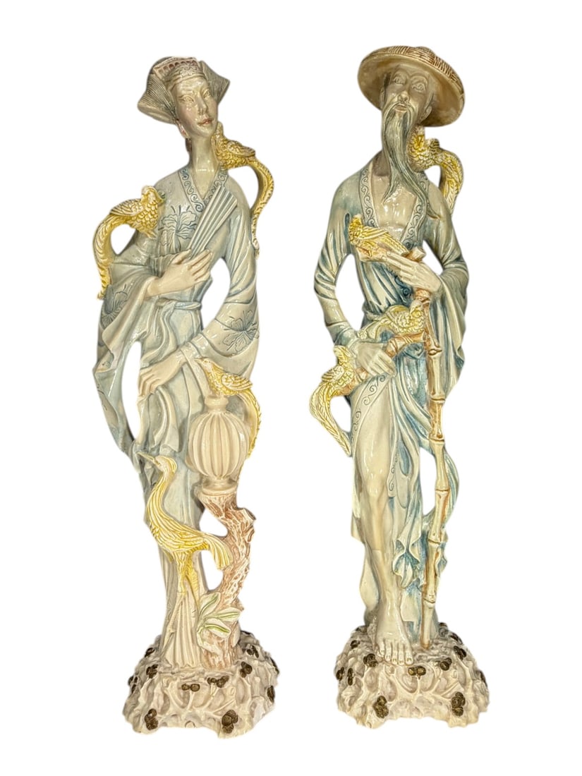 Large Chinese Resin Male & Female Sculptures 2pcs: Chinese pair of resin male and female figural sculptures depicting scholars in flowing robes with bird and naturalistic motifs, raised on organic form bases with celadon tone glaze and gilt accents. I