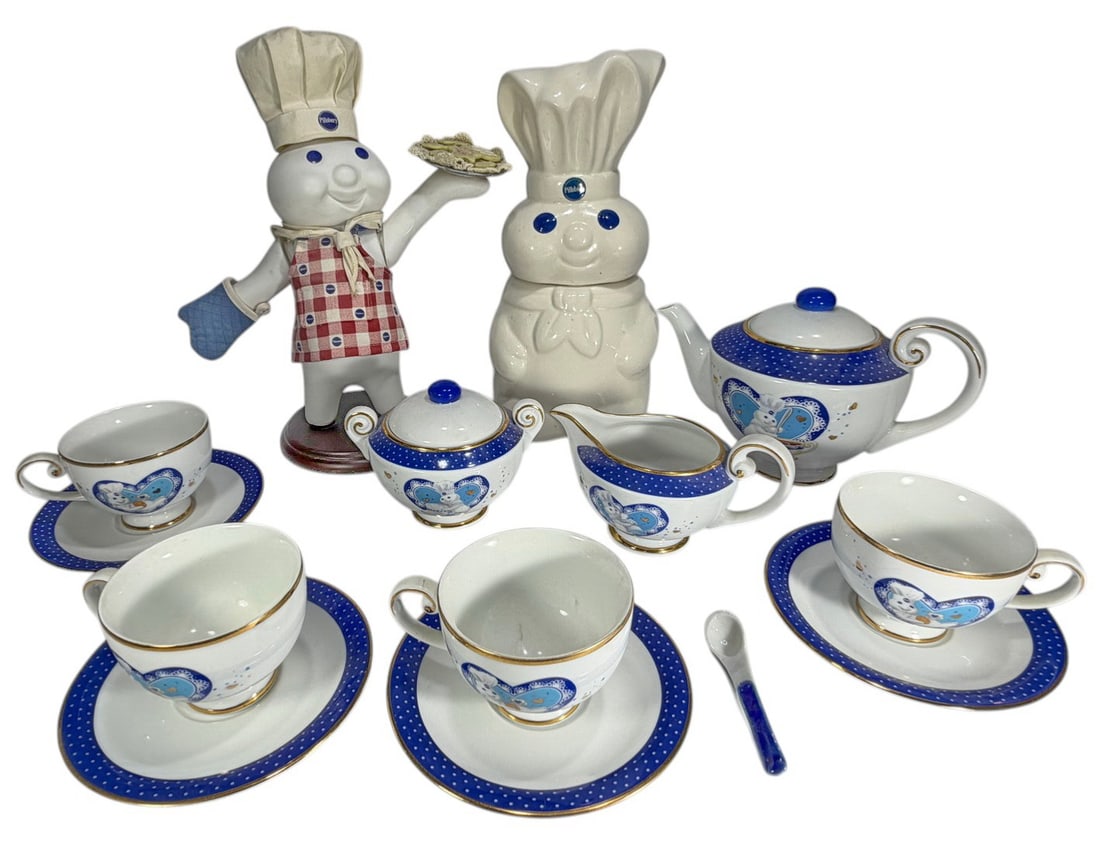 Pillsbury Doughboy Porcelain Tea Set Classic 14pcs: The Pillsbury Doughboy porcelain tea set by The Danbury Mint, includes teapot, creamer, lidded sugar, cups with saucers and spoon, with blue accents and Doughboy motifs, together with two larger figur