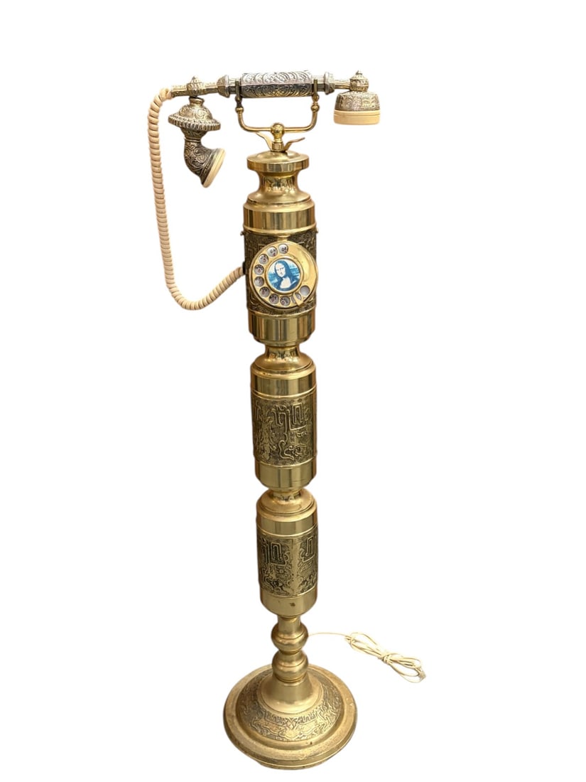 VTG French Style Brass Rotary Floor Telephone Deco: Vintage French style brass rotary floor telephone, column form with ornate cast panels, rotary dial and cradle handset, raised on circular base, marked 'ST 6020 Taiwan.'Dimensions: 41.5 X 9.5 X 8.75 i