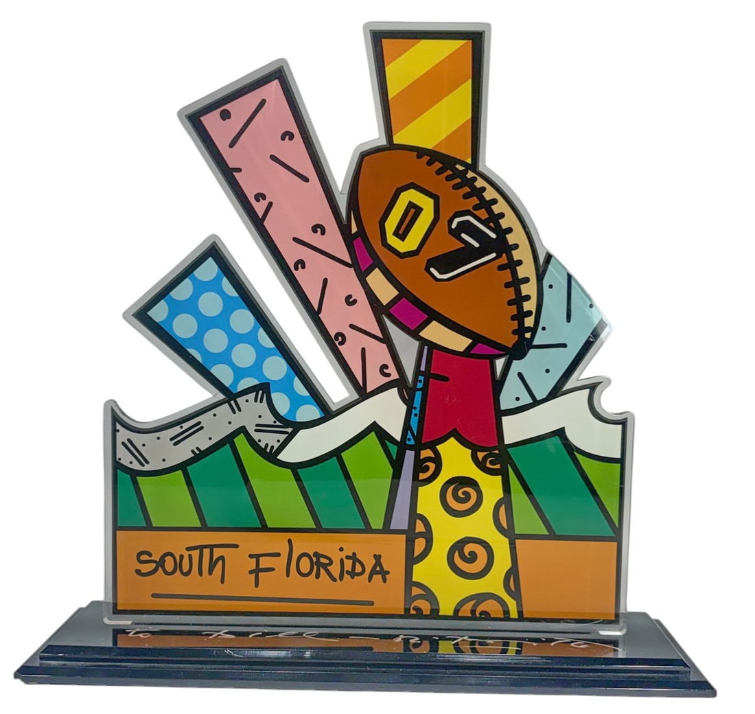 Romero Britto Brazilian b 1963 Acrylic Superbowl: Romero Britto, Brazilian born in 1963, an acrylic Pop Art Sculpture created in celebration of the Super Bowl in South Florida. Signed on the base and dedicated to Bill.Dimensions: 16 X 16.5 X 5 in. Co