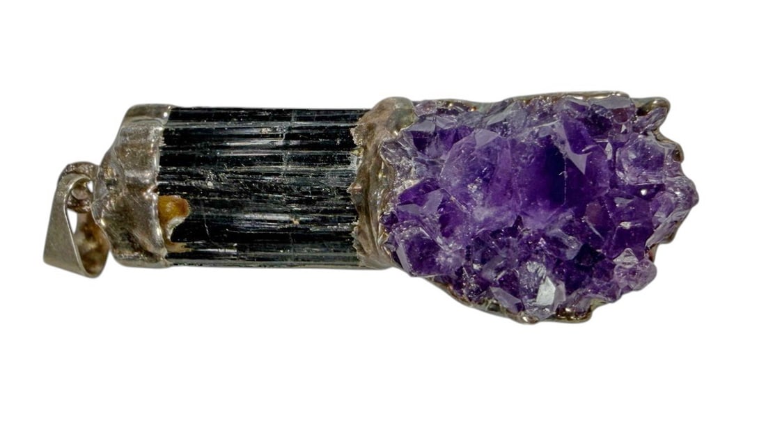 Amethyst & Raw Black Tourmaline Crystal Pendant: Handcrafted pendant featuring a natural amethyst and a raw black tourmaline crystal framed by a probably silver mount. Dimensions: 1.5 X 0.5 X 0.5 in. Condition: Good overall condition having norm